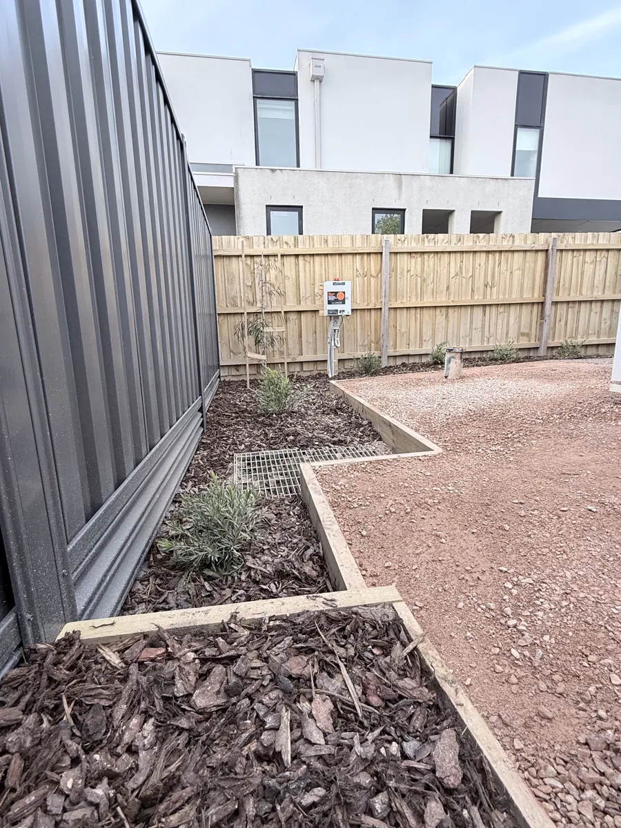 Timber boundary fencing and gravel courtyard on the Essendon units project