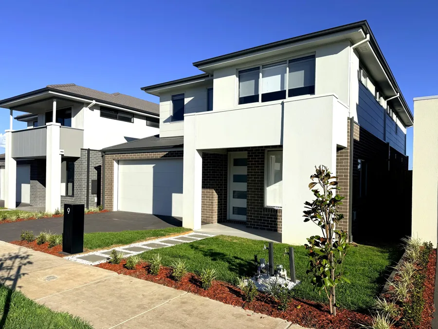 New two-storey home with block retaining, garden beds, turf and fencing finished by Melbourne Fencing Solutions